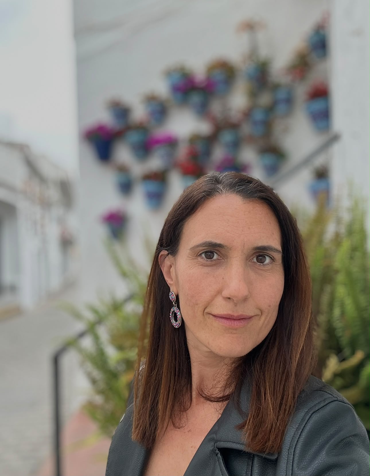 Bea Lamas smiling in a white-washed Andalusian street